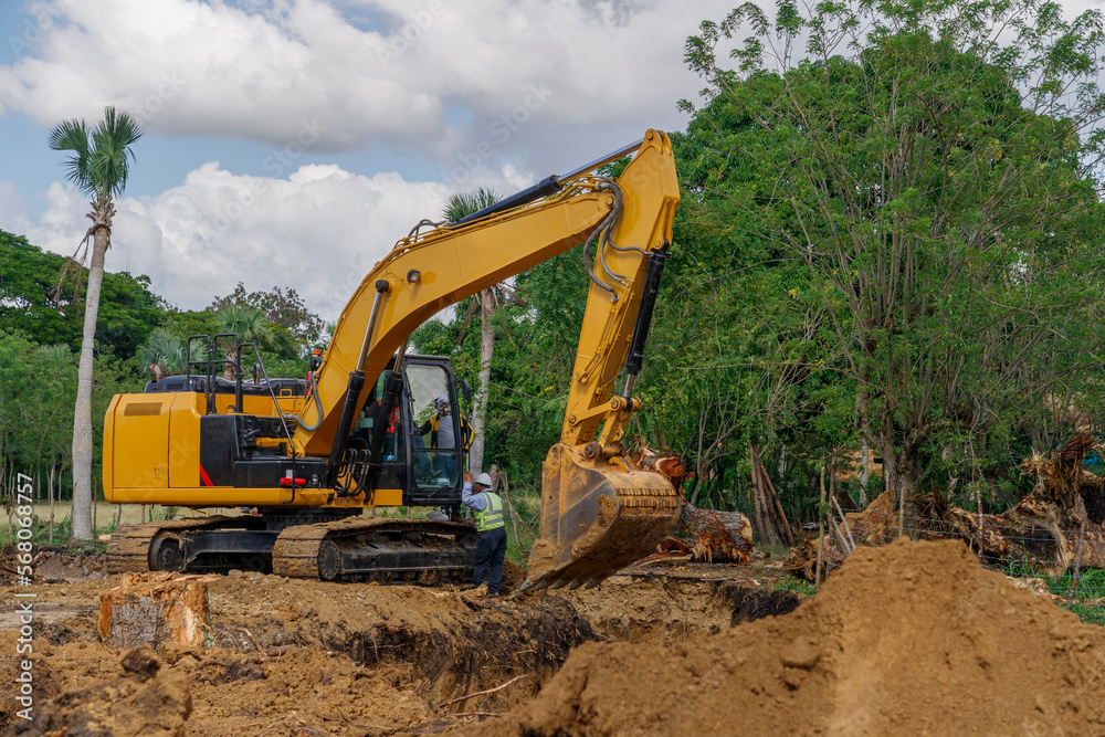 The excavator digs a trench. Excavation. The excavator digs a trench. Excavation.