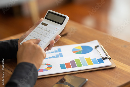 Business accounting concept, close-up shot of male businessman using calculator to analyze business idea.