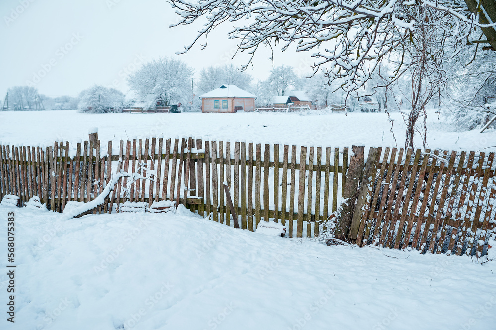 Old wooden rural fence under snow Old wooden rural fence under snow