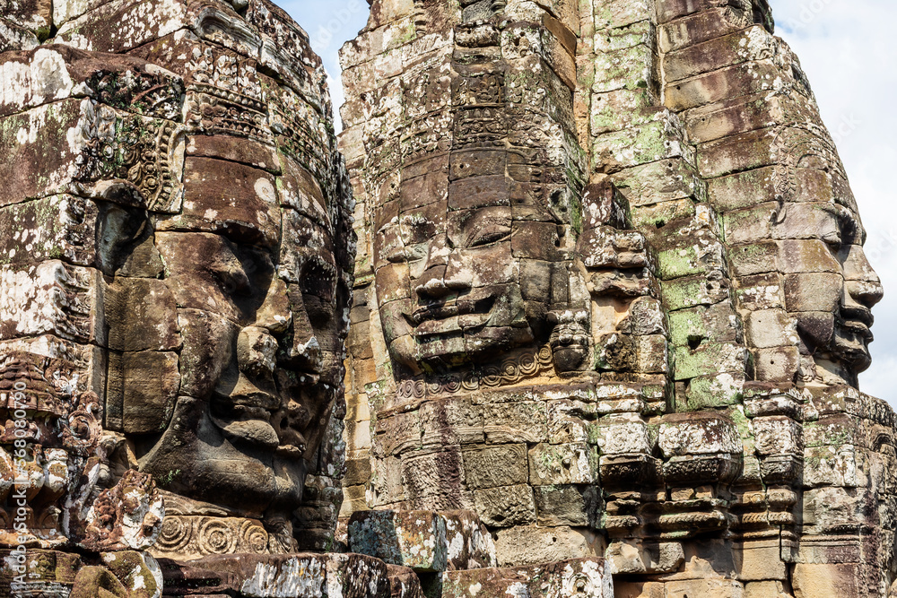 A few of the many smiling faces which can be found in the Bayon Temple, part of the Angkor Wat complex outside of Siem Reap, Cambodia. A few of the many smiling faces which can be found in the Bayon Temple, part of the Angkor Wat complex outside of Siem Reap, Cambodia.