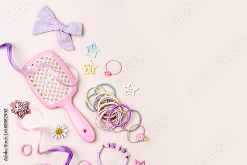 Set of baby girl hair accessories. Fashion hair bows, hair brush, hair clips, hairpins and hair elastics. Hairstyles for girls with stylish accessory.