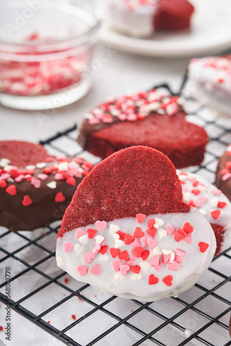 Valentines Day. Red velvet or brownie cookies on heart shaped in chocolate icing on a pink romantic background. Dessert idea for Valentines Day, Mothers or Womens Day. Tasty homemade cake for holiday
