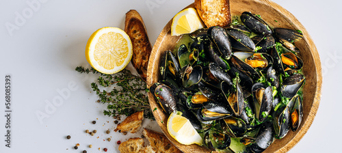 fragrant boiled mussels in herb and cream sauce photo
