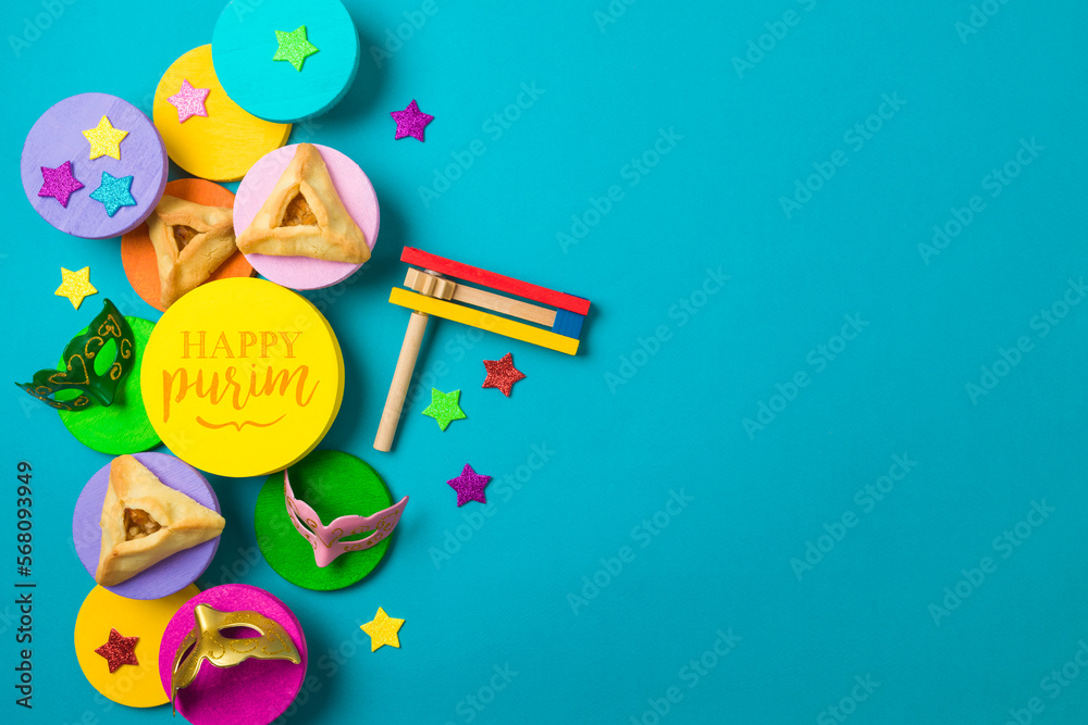 Fototapeta premium Purim festival creative border background with carnival mask and traditional cookies on colorful podiums. Top view, flat lay