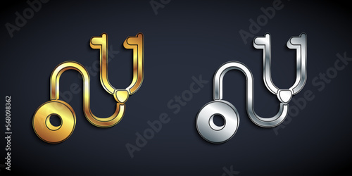 Gold and silver Stethoscope medical instrument icon isolated on black background. Long shadow style. Vector