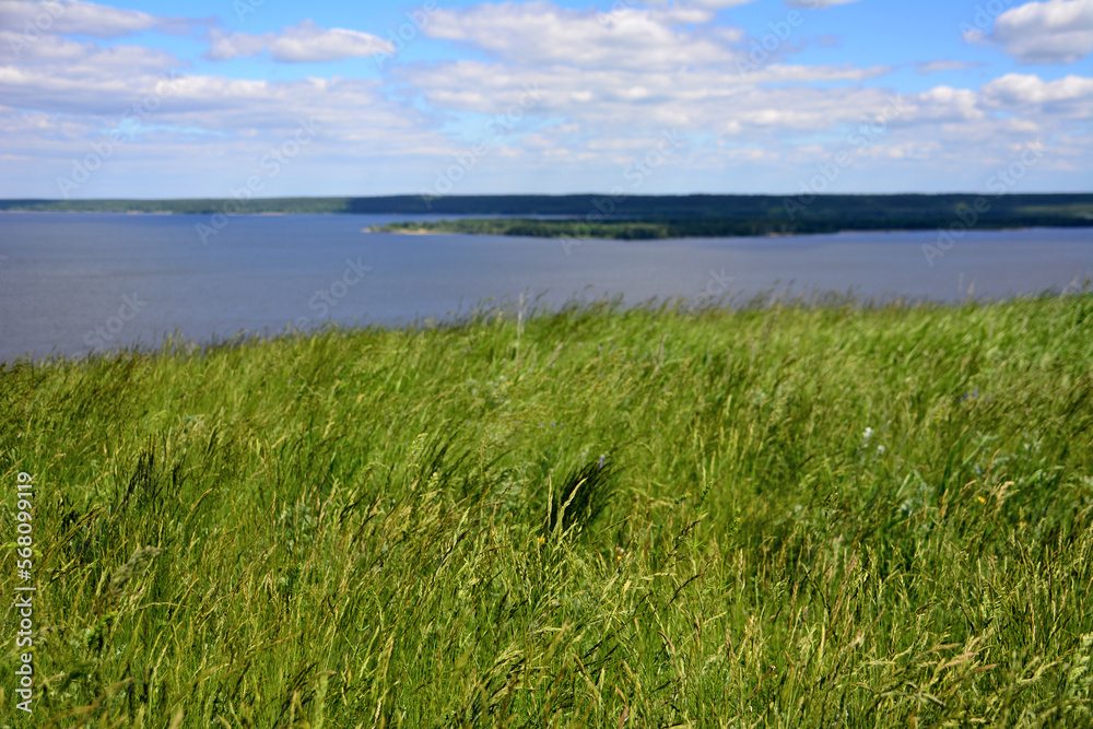 Volga river with island, blue sky and white clouds, view from top of the hill