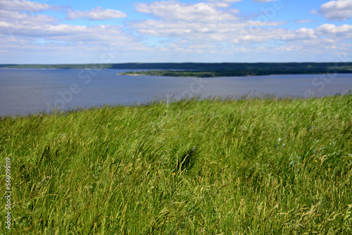 Volga river with island  blue sky and white clouds  view from top of the hill