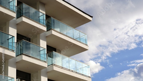 modern building with glass balconies against cloudy sky