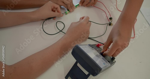 The group of Asian high school students are studying scientific experiment about electric current measurement in scientific laboratory. photo