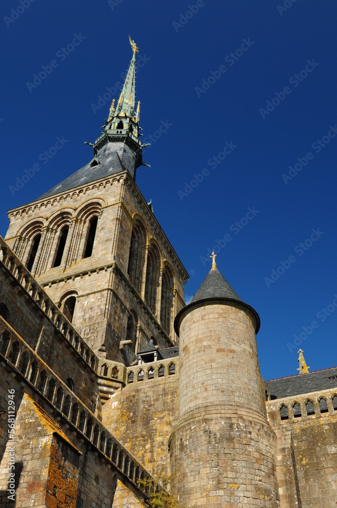 Bottom Up View To The Abbey Of The Famous Rocky Island Mont-Saint-Michel In Bretagne France On A Beautiful Sunny Summer Day With A Clear Blue Sky
