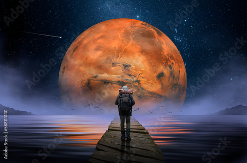 Backpacker walking on wooden footbridge with planet Mars in the background