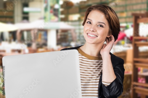 Positive woman working on laptop computer