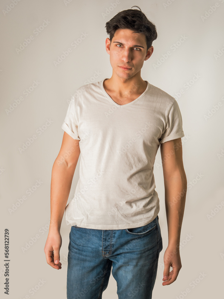 Handsome and fit young man standing on white background Handsome and fit young man standing on white background