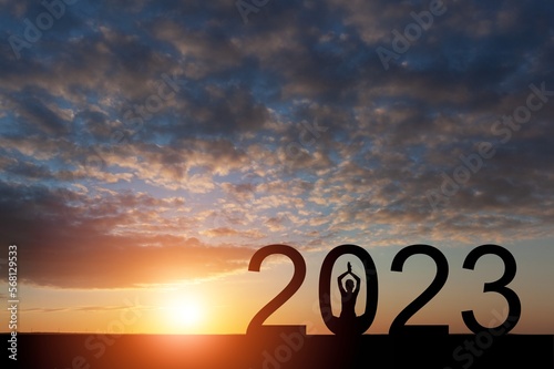Silhouette of meditating person and 2023 numbers