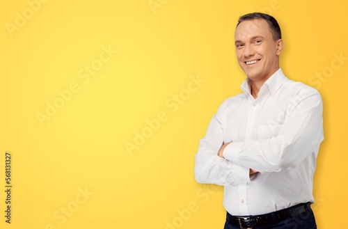 Smiling young man posing on color background