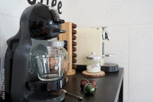 Coffee corner with two capsule coffee machines on brown wooden table
