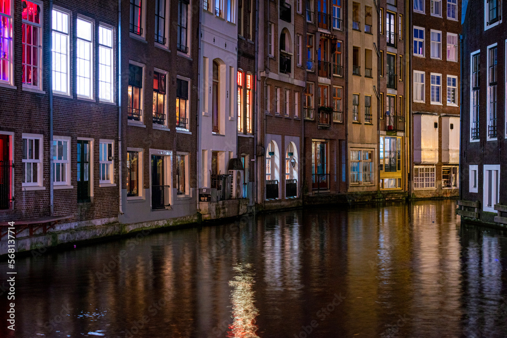 Long exposiure shot of a canal in Amsterdam, the Netherlands. beautiful and colorful lights during the night