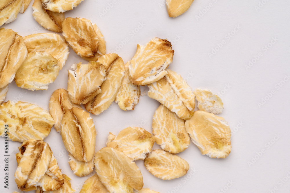 Fototapeta premium Macro photo of oatmeal on a white background,texture,background. Healthy, tasty food, a source of amino acids, minerals.