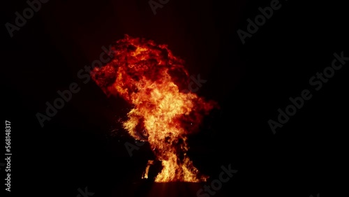 Impressive intense explosion on a black background. Dynamic composition of a detonating bright colorful explosion, shock wave and puffs of smoke filling the space
