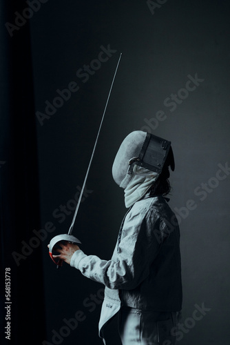 Photography beautiful man fencer with a foil rapier sword