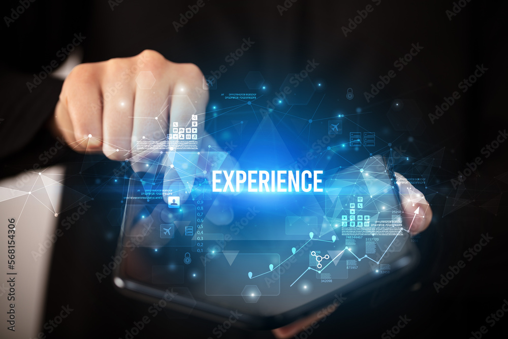 Businessman holding a foldable smartphone, business concept Businessman holding a foldable smartphone, business concept