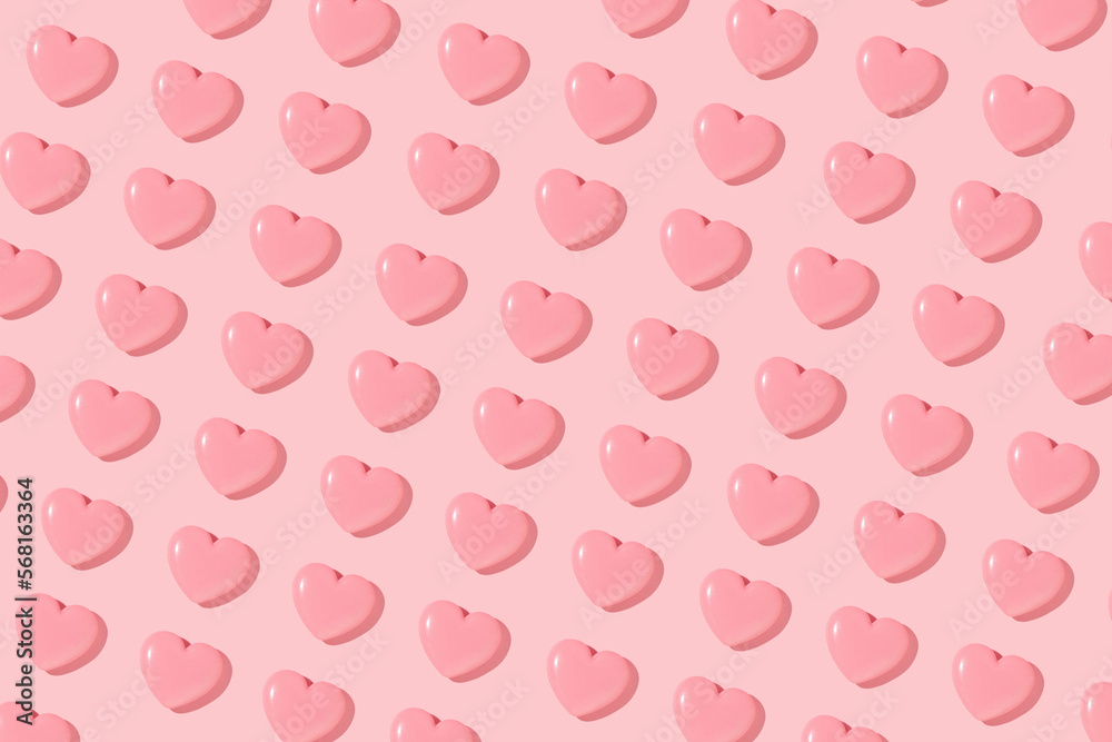 Valentines day creative pattern with baby pink hearts on pastel pink background. 80s or 90s retro fashion aesthetic love concept. Minimal romantic idea.