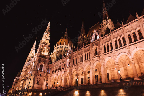Hungarian Parliament building and Danube River in the Budapest city at night. A sample of neo-gothic architecture, Budapest's tourist attraction