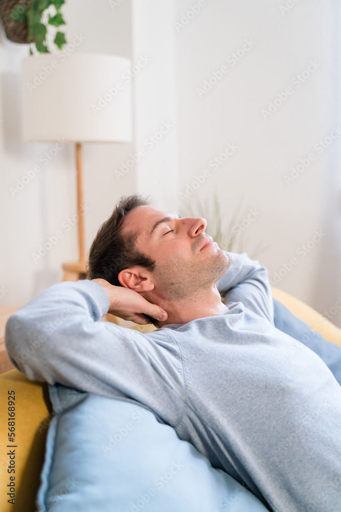 Relaxed man sleeping on sofa