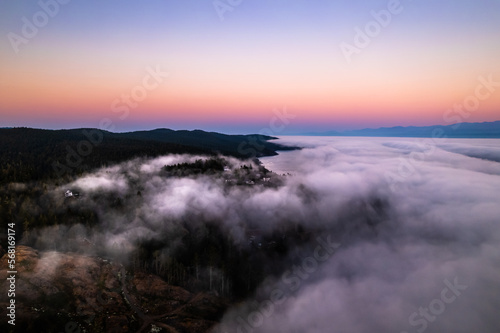 Aerial footage sunrise above clouds, fog bank, sea of clouds, beautiful serenity, peaceful morning sunrise.