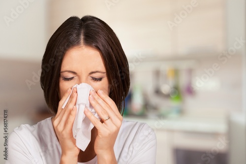 Sick young woman with fever, use tissues