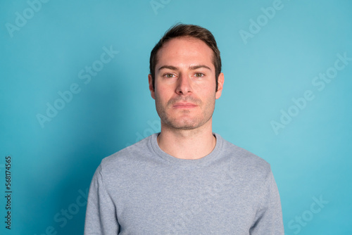 Serious young man looking at camera