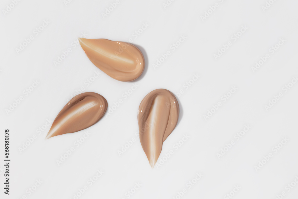 Makeup foundation, beige concealer swatch smudge smear on white background. BB CC cream texture