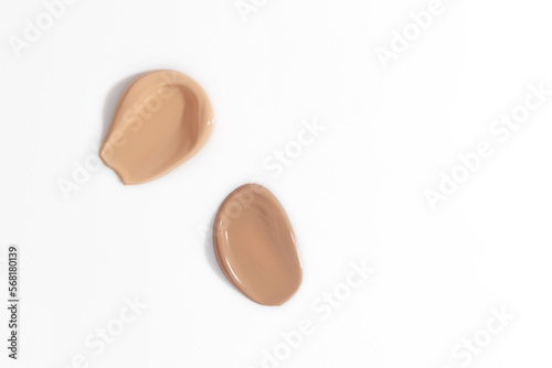 Makeup foundation, beige concealer swatch smudge smear on white background. BB CC cream texture