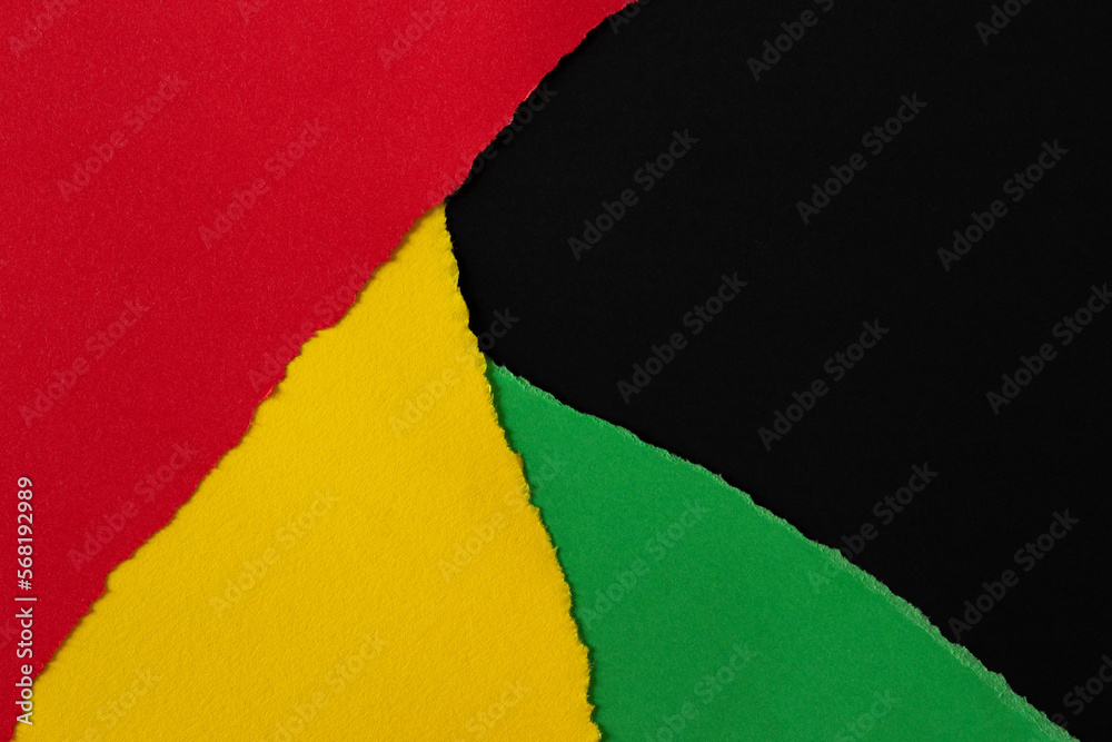 Abstract geometric black, red, yellow, green color paper background. Torn ripped paper collage