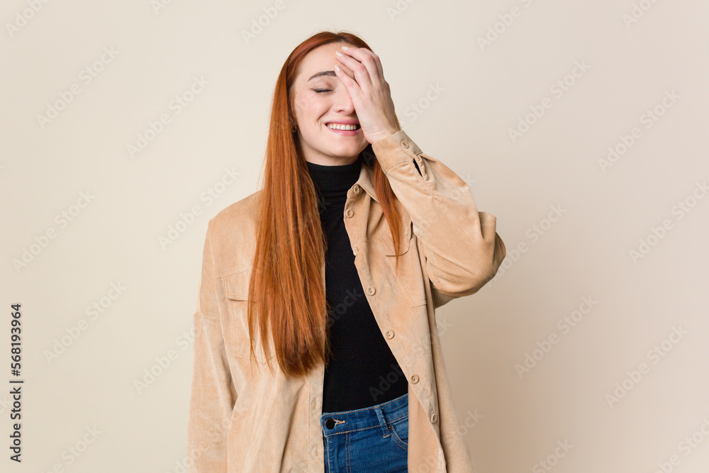 Young red hair woman isolated laughing happy, carefree, natural emotion. Young red hair woman isolated laughing happy, carefree, natural emotion.