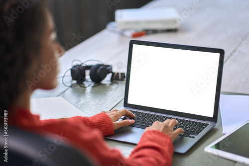 Over shoulder view of woman student elearning looking at white mock up blank screen using laptop computer learning online, remote working, searching on web. Website mockup display template. © insta_photos