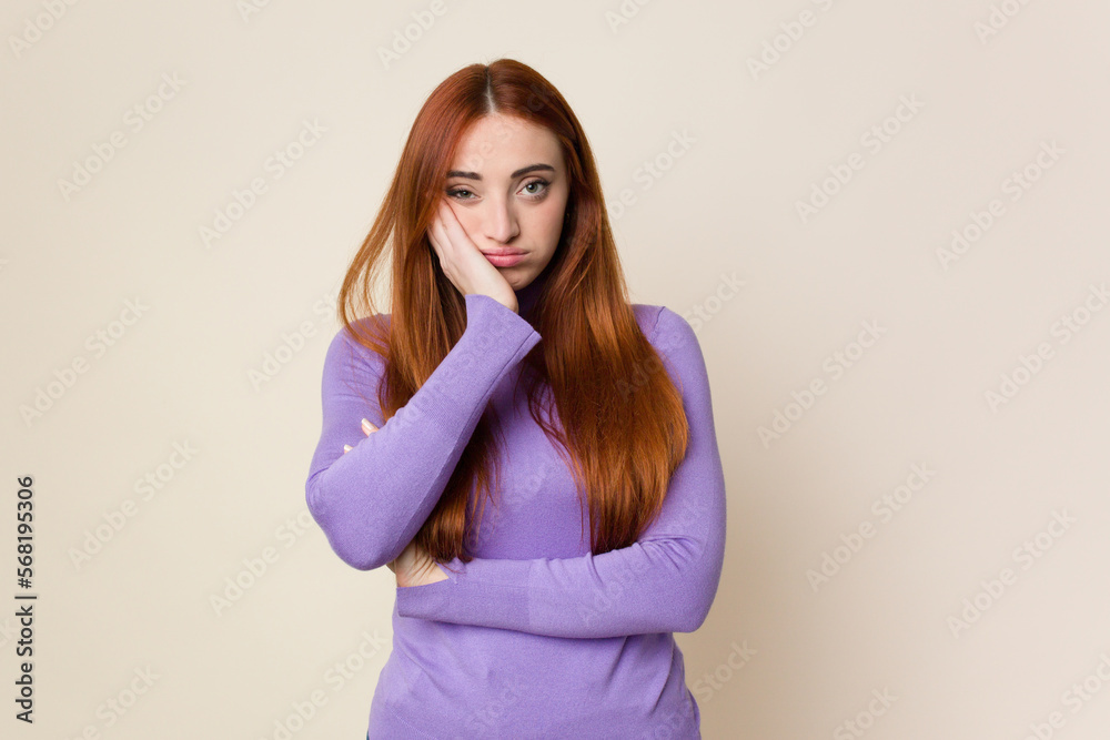 Young red hair woman isolated who is bored, fatigued and need a relax day. Young red hair woman isolated who is bored, fatigued and need a relax day.