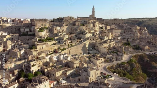 Aerial footage of Sassi di Matera in Basilicata, South Italy.Drone view of Sasso Caveoso and Civita districts, old city houses carved in rock caves, bell tower of Cathedral, Unesco heritage from above