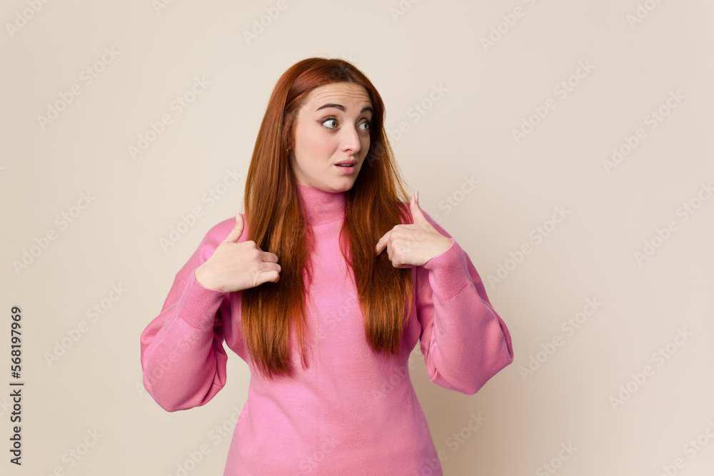 Young red hair woman isolated surprised pointing with finger, smiling broadly. Young red hair woman isolated surprised pointing with finger, smiling broadly.