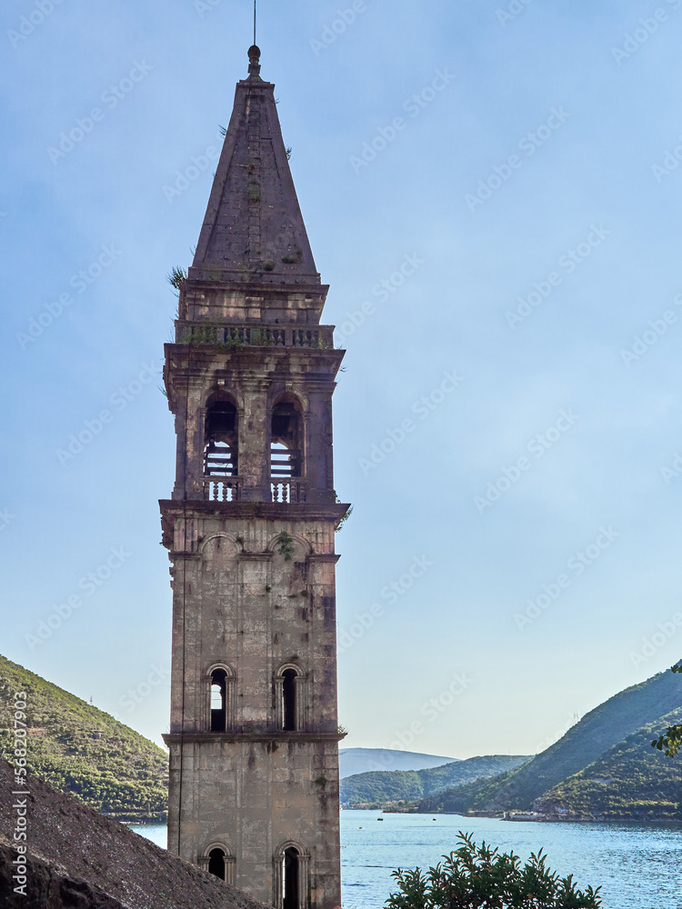 Belfry of St. Nicholas in Perast at sunset  with the bay of Kotor in the background. Montenegro, Europe