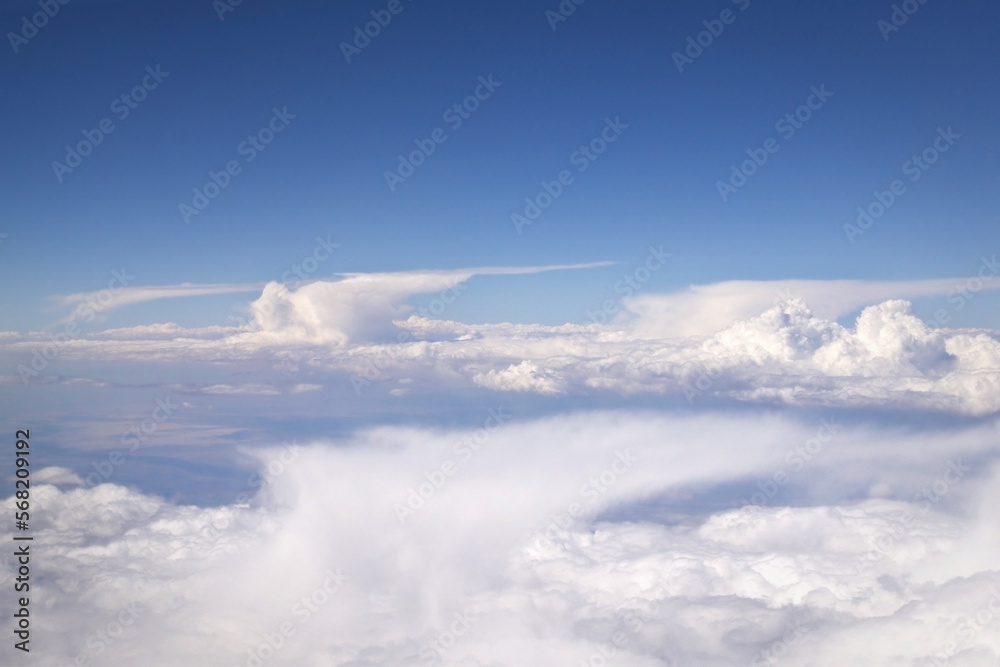 aerial view of four anvil cumulonimbus incus clouds in a blue sky aerial view of four anvil cumulonimbus incus clouds in a blue sky