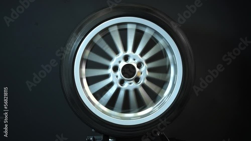 old car wheels titanium rims long exposure video on dark background spinning motion simulation