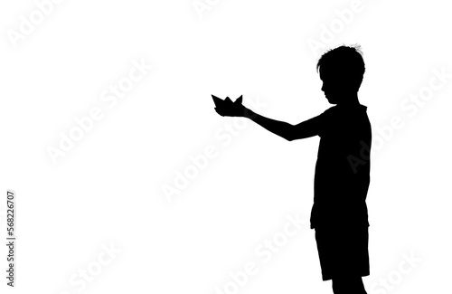 boy holds paper ship against water. Beautiful orange sunset. Paper boat. Origami. Orange sundown. Happy childhood concept