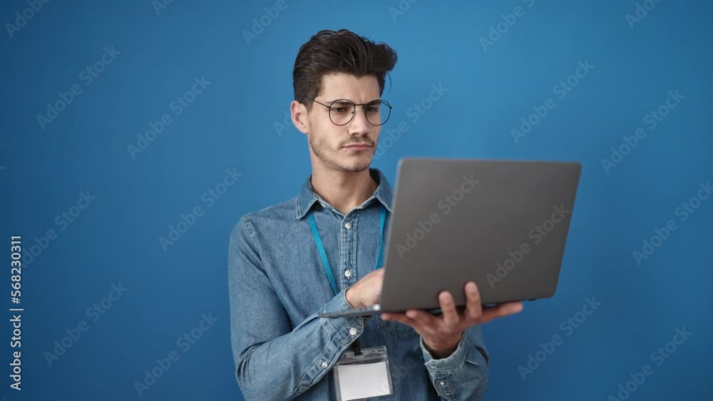 Young hispanic man smiling confident using laptop over isolated blue background