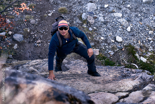 white man climbing a rock in patagonia