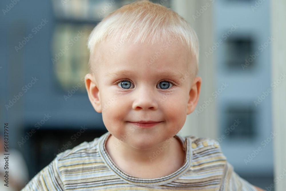 Close-up portrait of blonde kid with blue eyes. Concept of kindergarten, education and childhood. Close-up portrait of blonde kid with blue eyes. Concept of kindergarten, education and childhood.