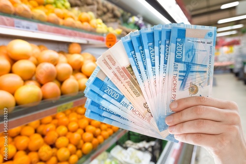 Money banknotes on background of food in market.