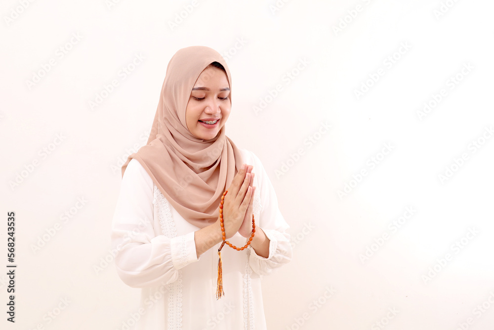 Young asian muslim woman standing with welcoming or greeting hand gesture. Isolated on white Young asian muslim woman standing with welcoming or greeting hand gesture. Isolated on white
