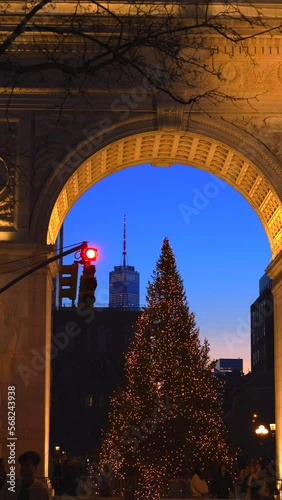 NEW YORK, NEW YORK – DECEMBER 30: The Christmas Tree stands in front of the Washington Square Arch in the dusk at Washington Square Park in Greenwich Village on December 30. 2022 in New York City.