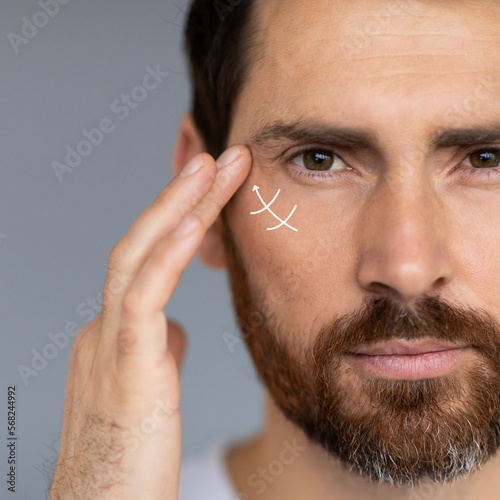 Fotografie Close up portrait of middle aged bearded man, wanting to lift face to remove wri